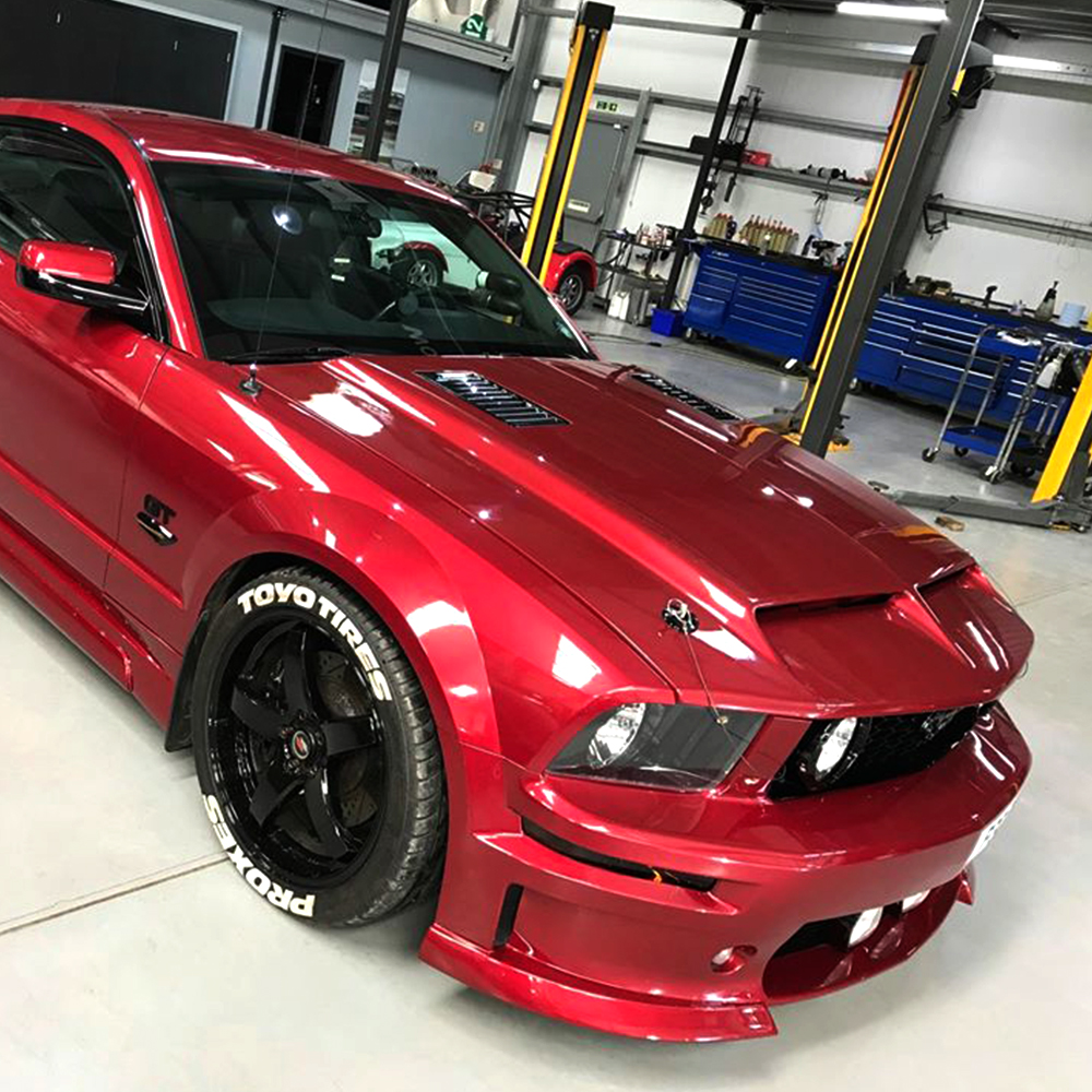 red mustang gt in topcats racing workshop