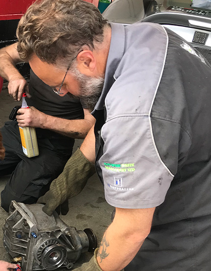 topcats racing team member working on rear differential
