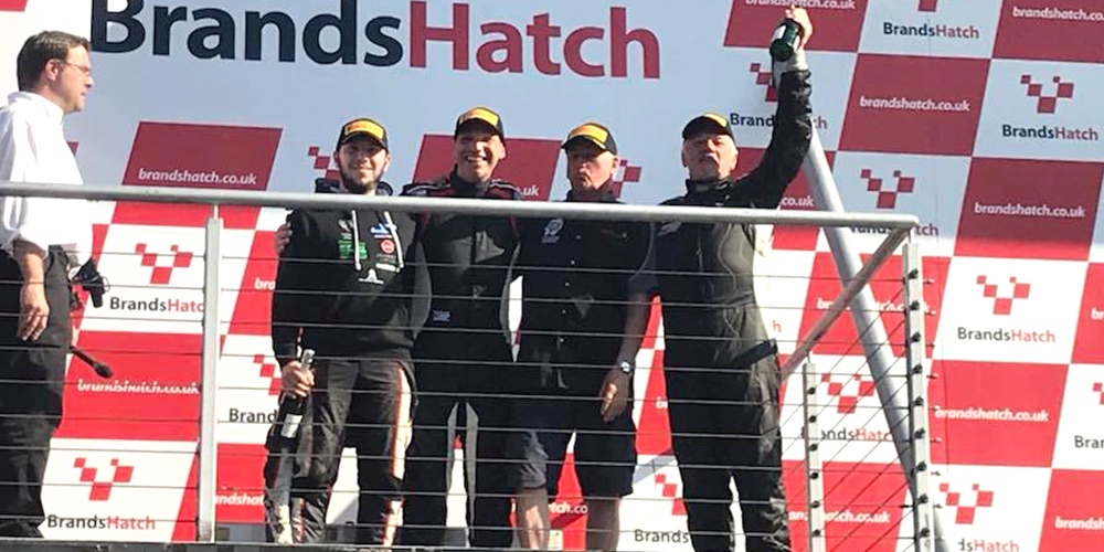 topcats racing team celebrating on podium at brands hatch