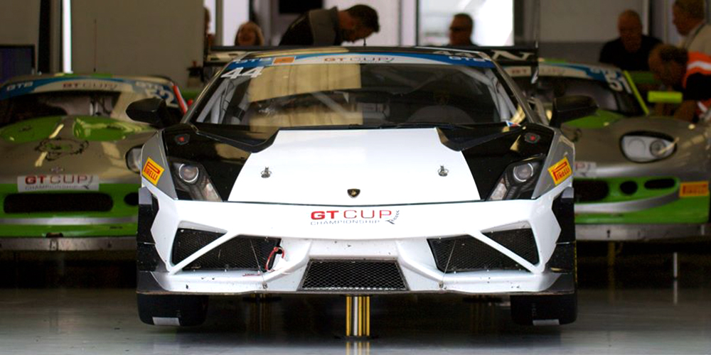 white and black topcats racing lamborghini gallardo performance car in workshop
