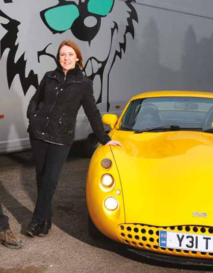 charlotte gilbert owner of topcats racing standing beside yellow tvr